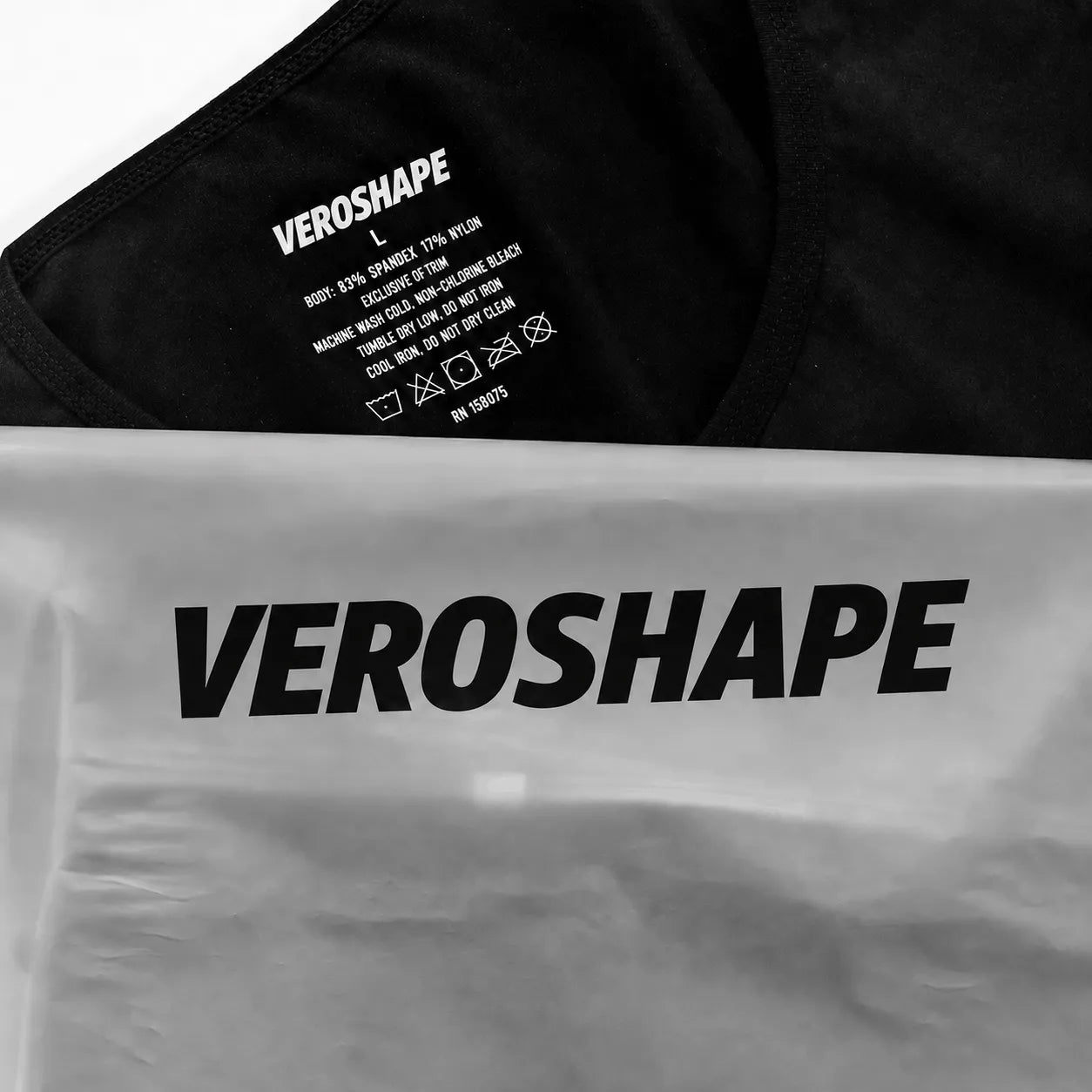 Close-up of the VEROSHAPE compression tank fabric label showing 83% spandex and 17% nylon beside the branded product packaging.